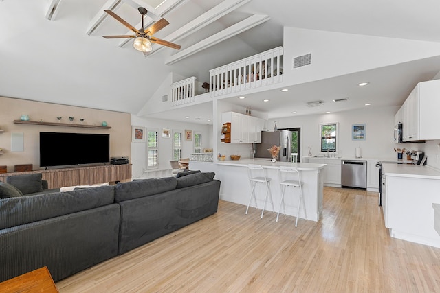 638 NE 8th Ave, Boynton Beach, FL 33435 - living area with plenty of natural light, ceiling fan, light wood-style flooring, high vaulted ceiling, and recessed lighting