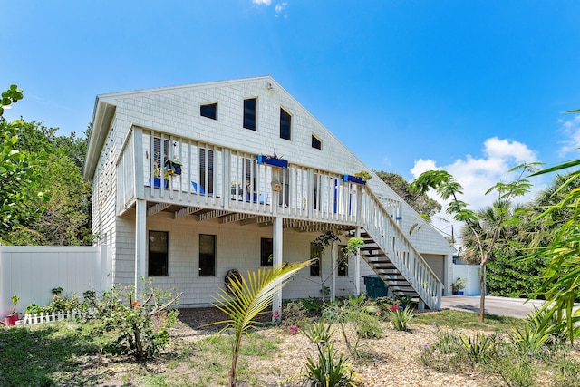 638 NE 8th Ave, Boynton Beach, FL 33435 - rear view of house with stairs, a deck, driveway, and a garage
