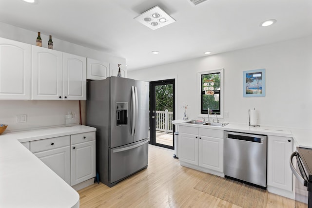 638 NE 8th Ave, Boynton Beach, FL 33435 - kitchen with appliances with stainless steel finishes, a sink, white cabinetry, and recessed lighting