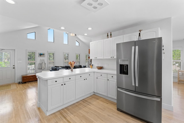 638 NE 8th Ave, Boynton Beach, FL 33435 - kitchen featuring stainless steel fridge, a peninsula, white cabinets, light wood finished floors, and light countertops