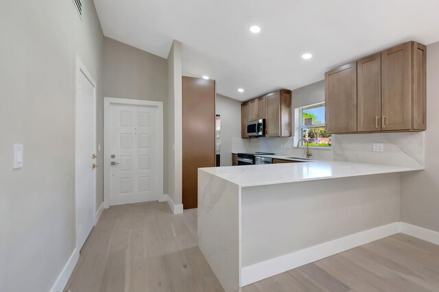 8164 Sweetbriar Way, Boca Raton, FL 33496 - kitchen with stainless steel microwave, light wood-style flooring, baseboards, and recessed lighting