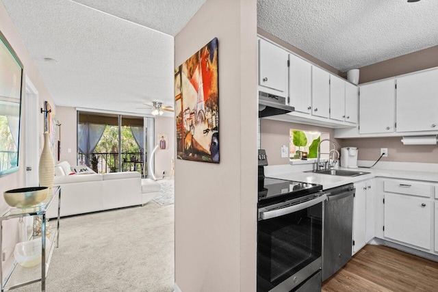 5100 Las Verdes Cir Unit 316, Delray Beach, FL 33484 - kitchen with appliances with stainless steel finishes, a sink, a textured ceiling, and white cabinets