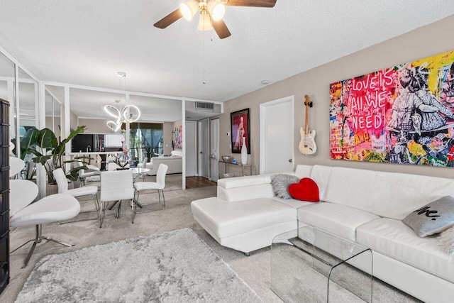 5100 Las Verdes Cir Unit 316, Delray Beach, FL 33484 - living room featuring a ceiling fan, a chandelier, a textured ceiling, and carpet flooring