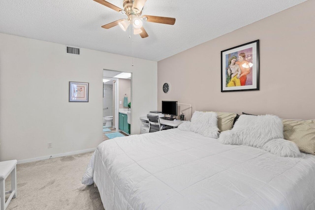 5100 Las Verdes Cir Unit 316, Delray Beach, FL 33484 - bedroom featuring light colored carpet, baseboards, connected bathroom, a textured ceiling, and a ceiling fan