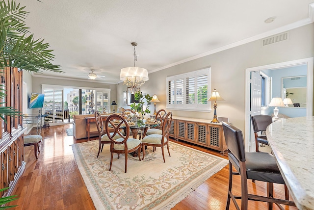 370 Golfview Rd Unit 304, North Palm Beach, FL 33408 - dining space with ornamental molding, hardwood / wood-style flooring, ceiling fan, and a chandelier
