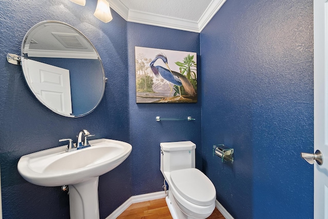 370 Golfview Rd Unit 304, North Palm Beach, FL 33408 - bathroom featuring crown molding, wood finished floors, toilet, and baseboards