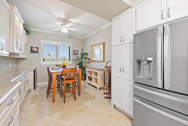 370 Golfview Rd Unit 304, North Palm Beach, FL 33408 - dining area featuring crown molding, a ceiling fan, baseboards, and light tile patterned flooring