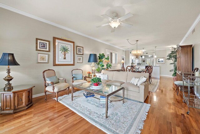 370 Golfview Rd Unit 304, North Palm Beach, FL 33408 - living area featuring crown molding, ceiling fan, light wood-style floors, a chandelier, and baseboards