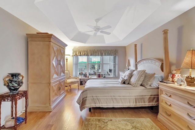 7714 Las Cruces Ct, Boynton Beach, FL 33437 - bedroom featuring a raised ceiling, light wood-style flooring, and ceiling fan