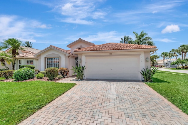 7714 Las Cruces Ct, Boynton Beach, FL 33437 - mediterranean / spanish-style house with stucco siding, decorative driveway, a front lawn, an attached garage, and a tile roof