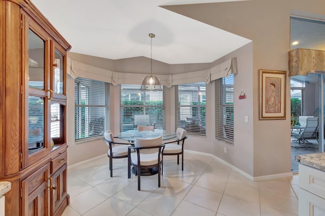 7714 Las Cruces Ct, Boynton Beach, FL 33437 - dining space with baseboards, vaulted ceiling, and light tile patterned floors