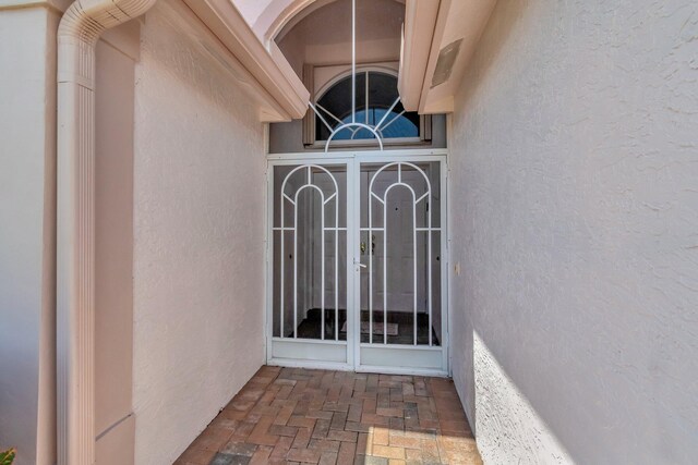 7714 Las Cruces Ct, Boynton Beach, FL 33437 - doorway to property with stucco siding