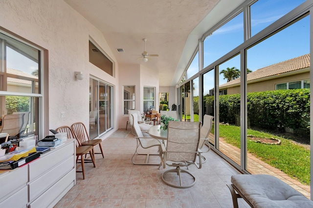 7714 Las Cruces Ct, Boynton Beach, FL 33437 - sunroom featuring ceiling fan, outdoor dining space, a textured wall, and vaulted ceiling