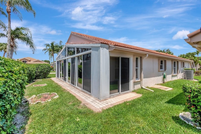7714 Las Cruces Ct, Boynton Beach, FL 33437 - rear view of house featuring stucco siding, central AC unit, a lawn, and a tile roof