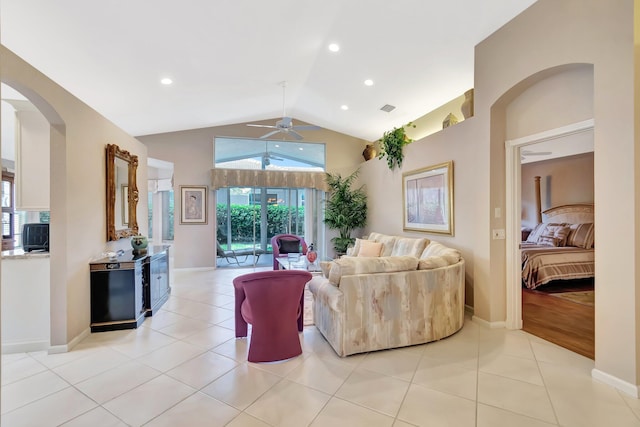 7714 Las Cruces Ct, Boynton Beach, FL 33437 - living area with vaulted ceiling, a ceiling fan, arched walkways, light tile patterned flooring, and baseboards