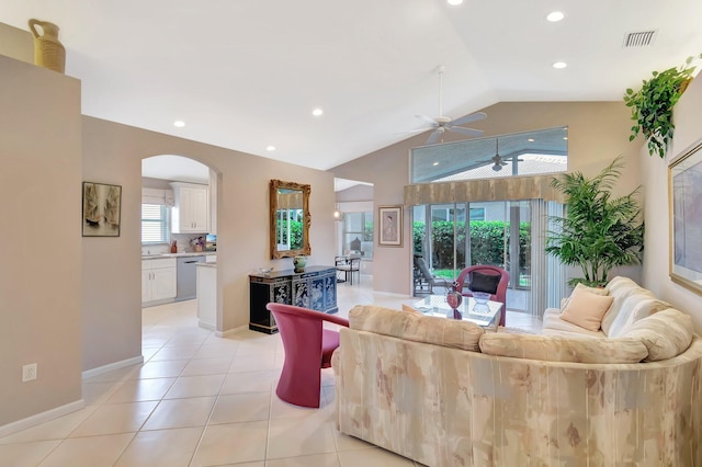 7714 Las Cruces Ct, Boynton Beach, FL 33437 - living room featuring ceiling fan, arched walkways, vaulted ceiling, light tile patterned flooring, and baseboards