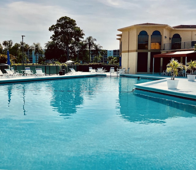 3590 Via Poinciana Unit 303, Lake Worth, FL 33467 - community pool featuring a patio