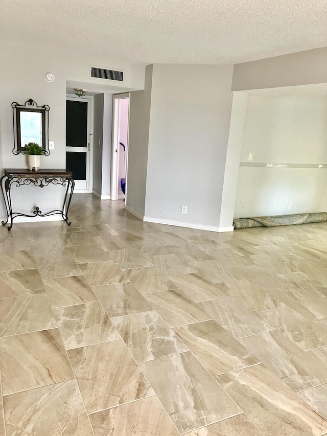 3590 Via Poinciana Unit 303, Lake Worth, FL 33467 - empty room featuring a textured ceiling and baseboards