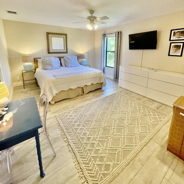470 S Mars Way NE, Juno Beach, FL 33408 - bedroom featuring light wood-style floors, a ceiling fan, and baseboards