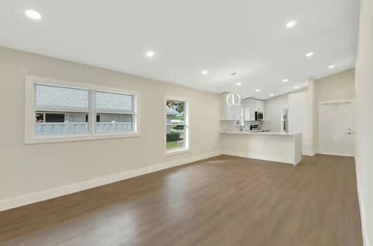 8914 Windtree St, Boca Raton, FL 33496 - unfurnished living room with wood finished floors, baseboards, and recessed lighting