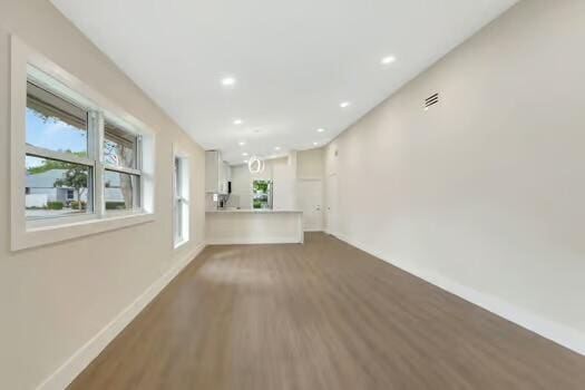 8914 Windtree St, Boca Raton, FL 33496 - unfurnished living room with wood finished floors, baseboards, and recessed lighting
