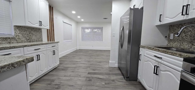 1510 S 23rd Ave, Hollywood, FL 33020 - kitchen with freestanding refrigerator, a sink, white cabinets, baseboards, and recessed lighting