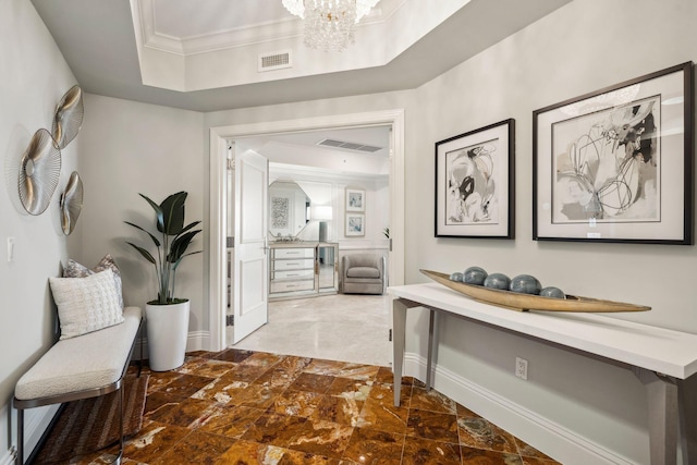 5050 N Ocean Dr Unit 701, Singer Island, FL 33404 - hallway featuring crown molding, a chandelier, and baseboards