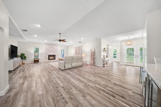 7903 Plantation Lakes Dr NW, Port Saint Lucie, FL 34986 - living area featuring light wood-style floors, ceiling fan, a stone fireplace, baseboards, and recessed lighting