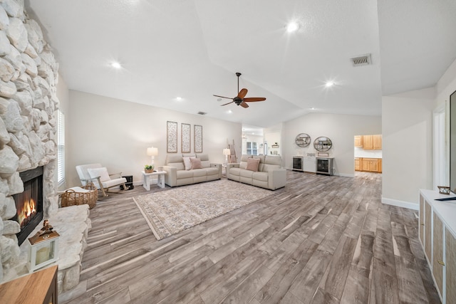 7903 Plantation Lakes Dr NW, Port Saint Lucie, FL 34986 - living room featuring a fireplace, wood finished floors, lofted ceiling, a ceiling fan, and baseboards