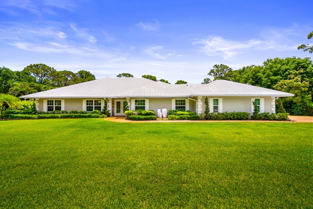 7903 Plantation Lakes Dr NW, Port Saint Lucie, FL 34986 - ranch-style house with a front lawn, metal roof, and stucco siding
