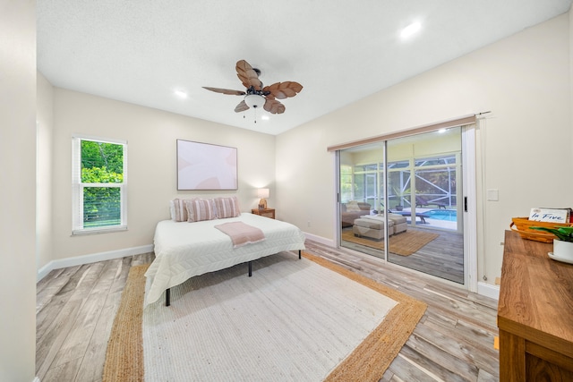 7903 Plantation Lakes Dr NW, Port Saint Lucie, FL 34986 - bedroom featuring access to exterior, light wood-style flooring, baseboards, and recessed lighting
