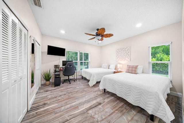 7903 Plantation Lakes Dr NW, Port Saint Lucie, FL 34986 - bedroom with wood finished floors, an office area, recessed lighting, multiple closets, and ceiling fan