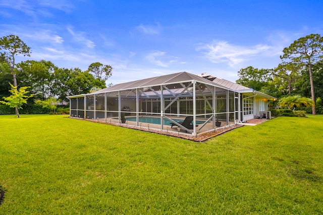 7903 Plantation Lakes Dr NW, Port Saint Lucie, FL 34986 - swimming pool featuring a lawn, a lanai, and a patio area