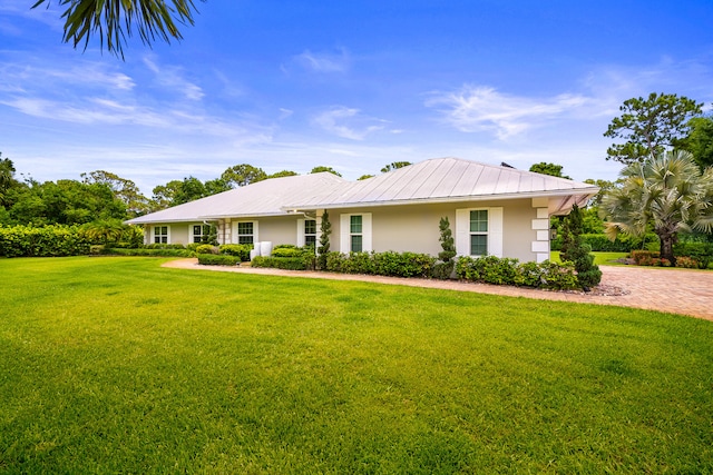 7903 Plantation Lakes Dr NW, Port Saint Lucie, FL 34986 - ranch-style house with stucco siding, a front yard, and metal roof