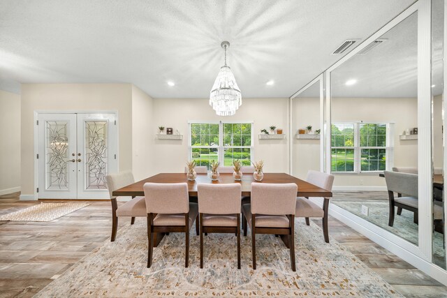 7903 Plantation Lakes Dr NW, Port Saint Lucie, FL 34986 - dining area with french doors, a chandelier, baseboards, wood finished floors, and recessed lighting