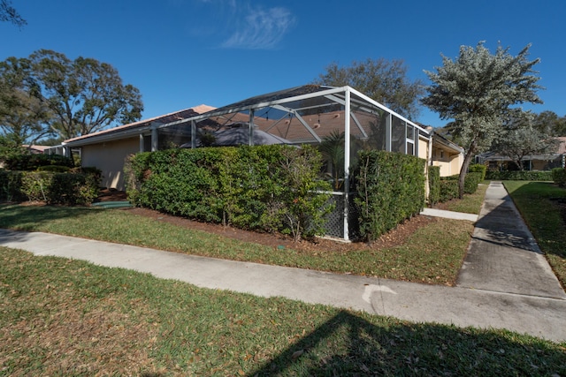 9132 Sun Terrace Cir Unit D, Palm Beach Gardens, FL 33403 - view of home's exterior with glass enclosure and a yard