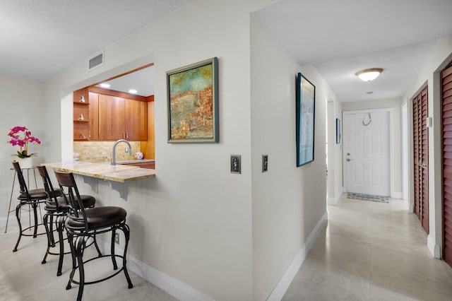 9628 Pavarotti Ter Unit 101, Boynton Beach, FL 33437 - corridor with baseboards, a sink, and recessed lighting