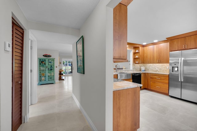 9628 Pavarotti Ter Unit 101, Boynton Beach, FL 33437 - kitchen featuring stainless steel refrigerator with ice dispenser, dishwasher, light countertops, decorative backsplash, and brown cabinetry