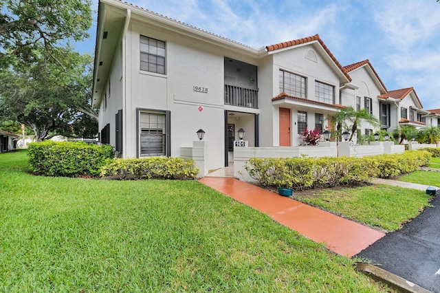 9628 Pavarotti Ter Unit 101, Boynton Beach, FL 33437 - view of front of home with a front lawn, stucco siding, and a tiled roof