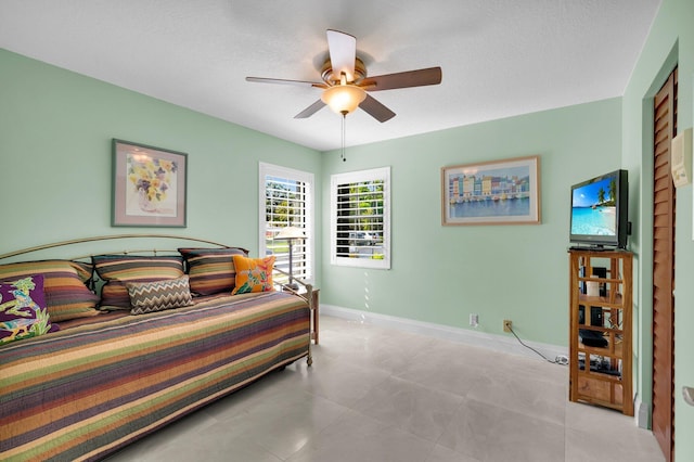 9628 Pavarotti Ter Unit 101, Boynton Beach, FL 33437 - tiled bedroom featuring baseboards and ceiling fan
