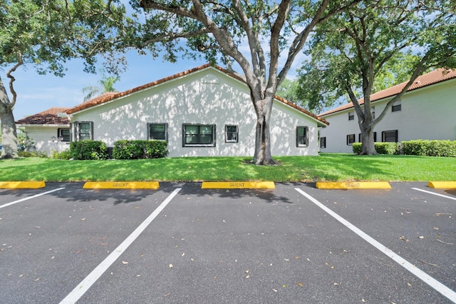 9628 Pavarotti Ter Unit 101, Boynton Beach, FL 33437 - view of building exterior with uncovered parking