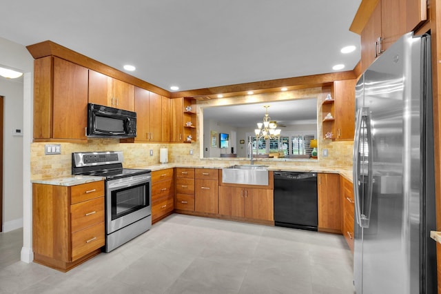 9628 Pavarotti Ter Unit 101, Boynton Beach, FL 33437 - kitchen featuring black appliances, open shelves, a sink, a chandelier, and brown cabinets