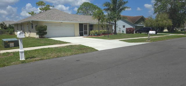 8205 Winnipesaukee Way, Lake Worth, FL 33467 - ranch-style home with a garage, a front yard, concrete driveway, and stucco siding