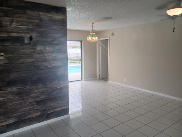 8205 Winnipesaukee Way, Lake Worth, FL 33467 - tiled empty room featuring baseboards, ceiling fan, and a textured ceiling