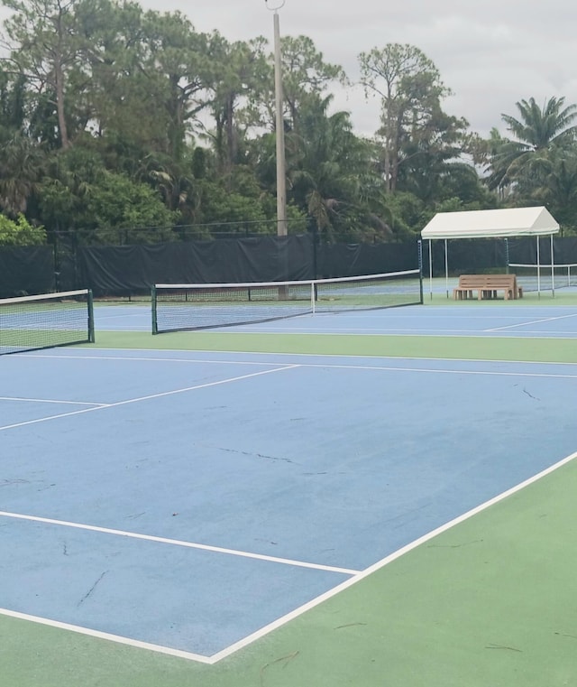 8205 Winnipesaukee Way, Lake Worth, FL 33467 - view of tennis court featuring view of scattered trees