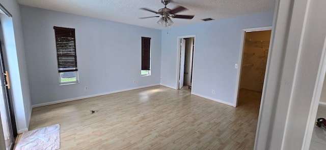8205 Winnipesaukee Way, Lake Worth, FL 33467 - empty room with light wood-style floors, a ceiling fan, a textured ceiling, and baseboards