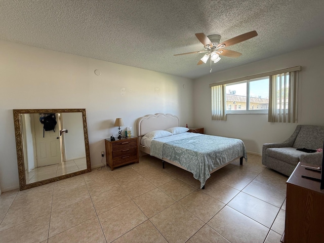 709 Lori Dr Unit 301, Palm Springs, FL 33461 - bedroom with light tile patterned floors, a textured ceiling, ceiling fan, and baseboards