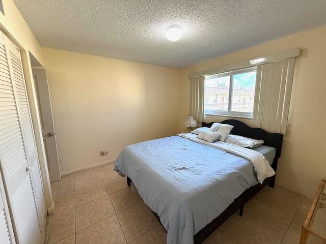 709 Lori Dr Unit 301, Palm Springs, FL 33461 - bedroom with a textured ceiling and light tile patterned flooring