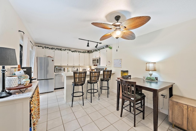 506 5th Ter, Palm Beach Gardens, FL 33418 - dining area with a ceiling fan, light tile patterned flooring, and rail lighting