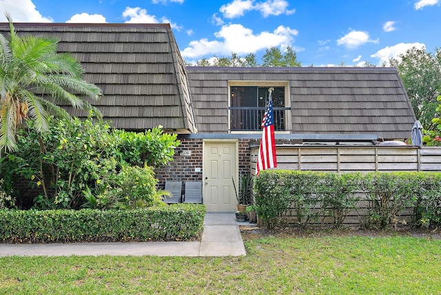 506 5th Ter, Palm Beach Gardens, FL 33418 - property entrance featuring brick siding and mansard roof